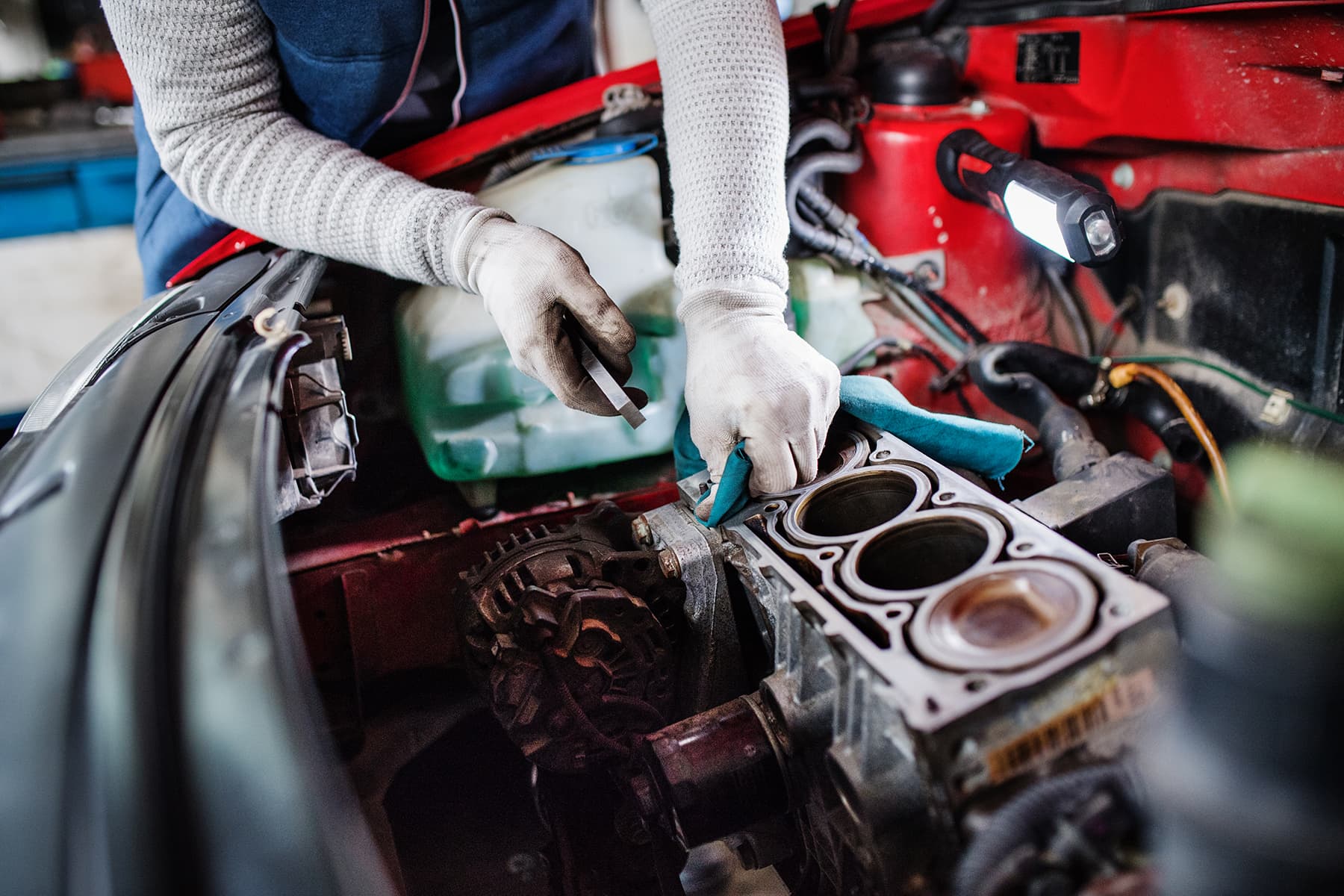 Mechanic repairing a car engine in a garage